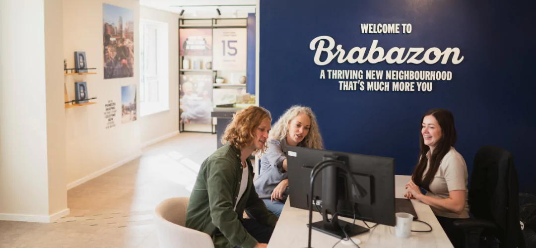 man and woman speaking with a New homes Consultant in the show home at Brabazon, Bristol.