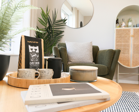 Seating area with a plush green armchair in a new home at Brabazon.