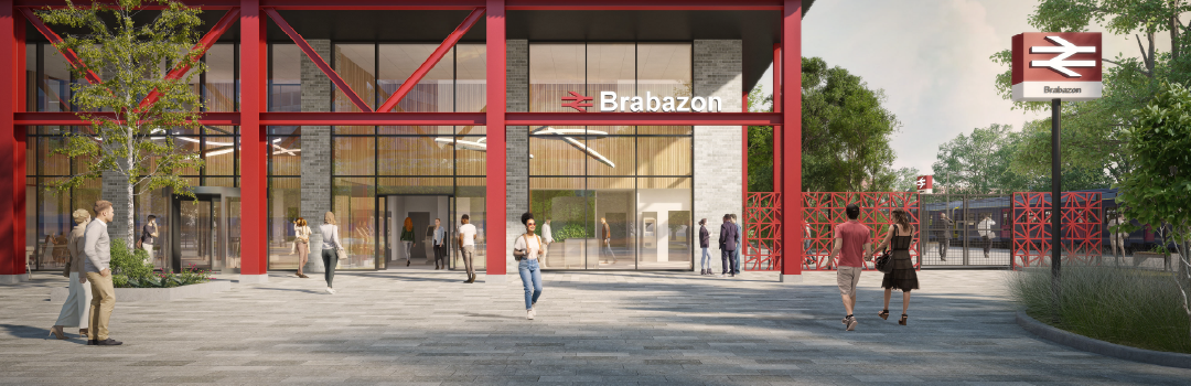 CGI of Pedestrians walking towards the modern Bristol Brabazon train station. The building features large glass windows, red steel beams, and surrounding greenery.