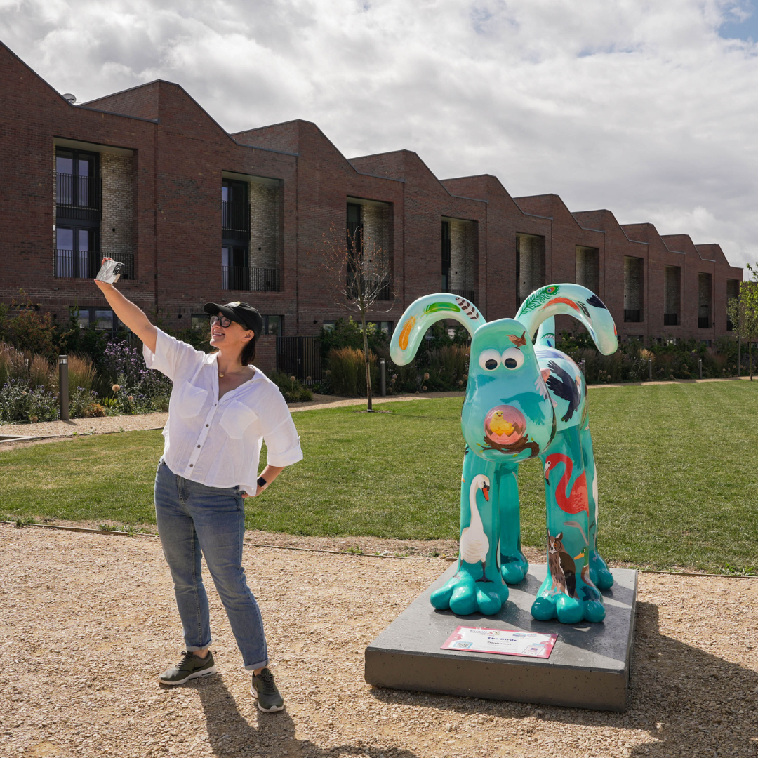 Woman taking a selfie in front of Gromit The Birds statue at Brabazon.