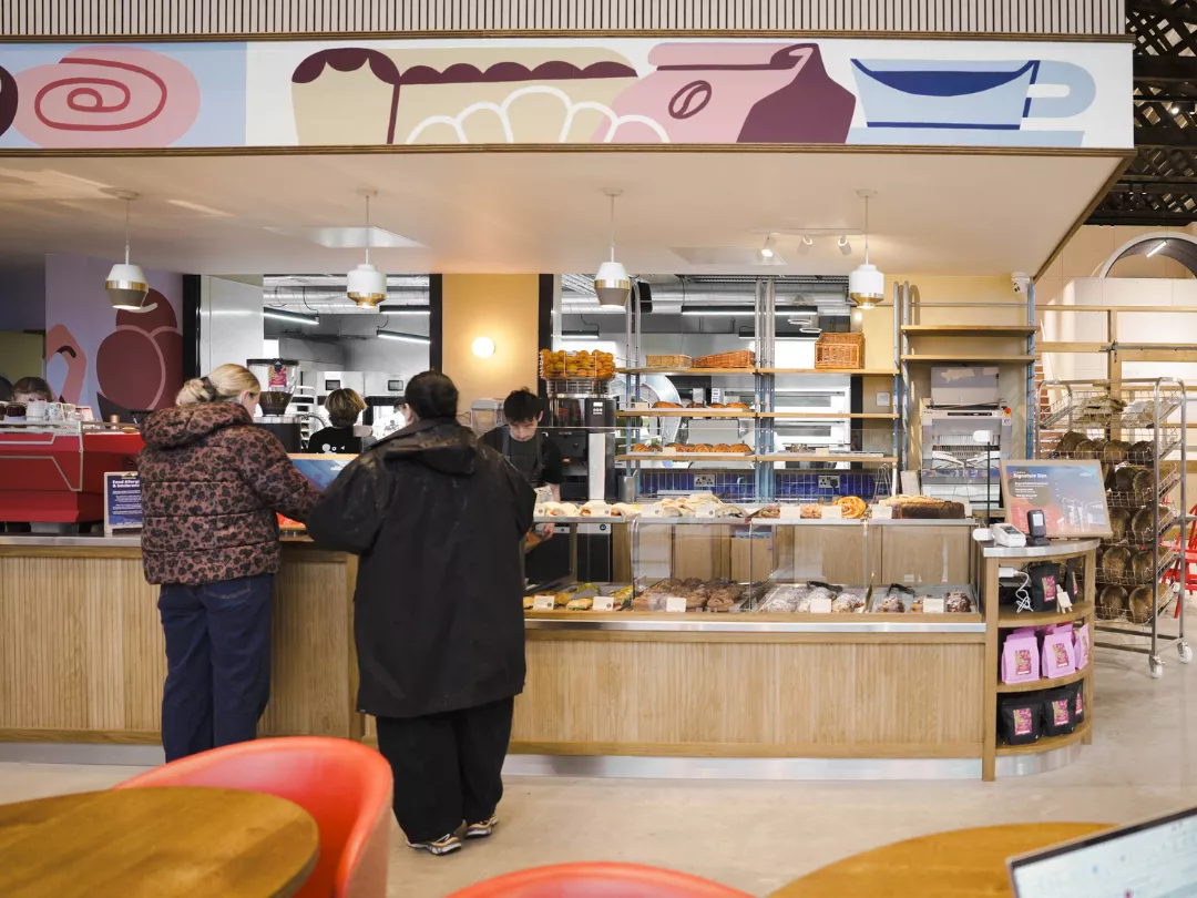 Visitors being served at the counter of Mokoko Bakery at Spitfire Hangar.