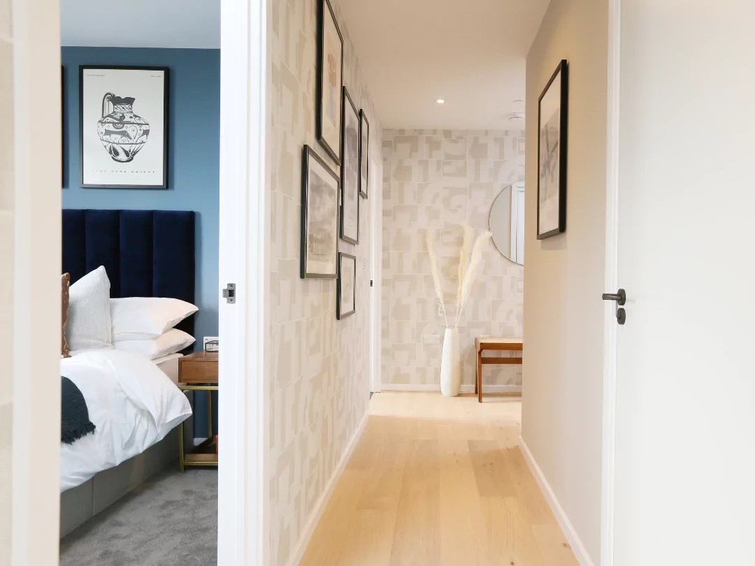 Hallway and bedroom in a modern apartment with light wood flooring.