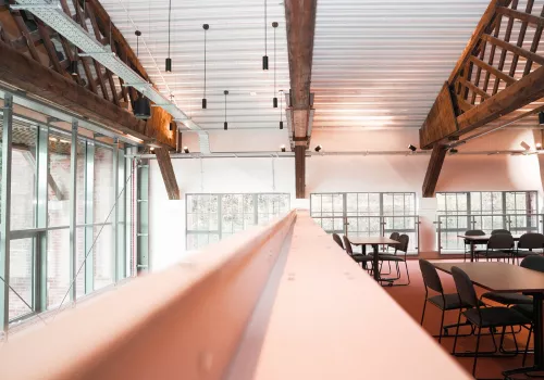 Mezzanine meeting space set up with table and chairs as a meeting room for hire.