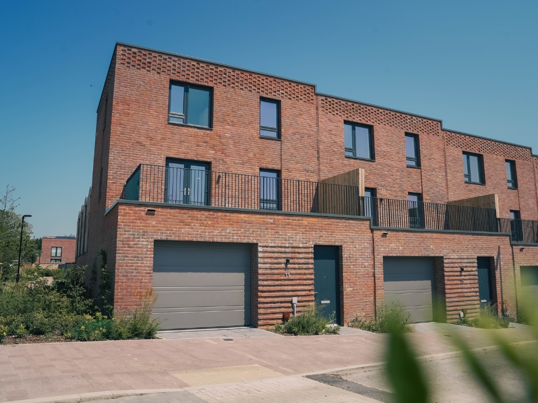 The Buckingham contemporary red-brick townhouses at Brabazon, featuring private terraces, integrated garages and landscaped streetscape.