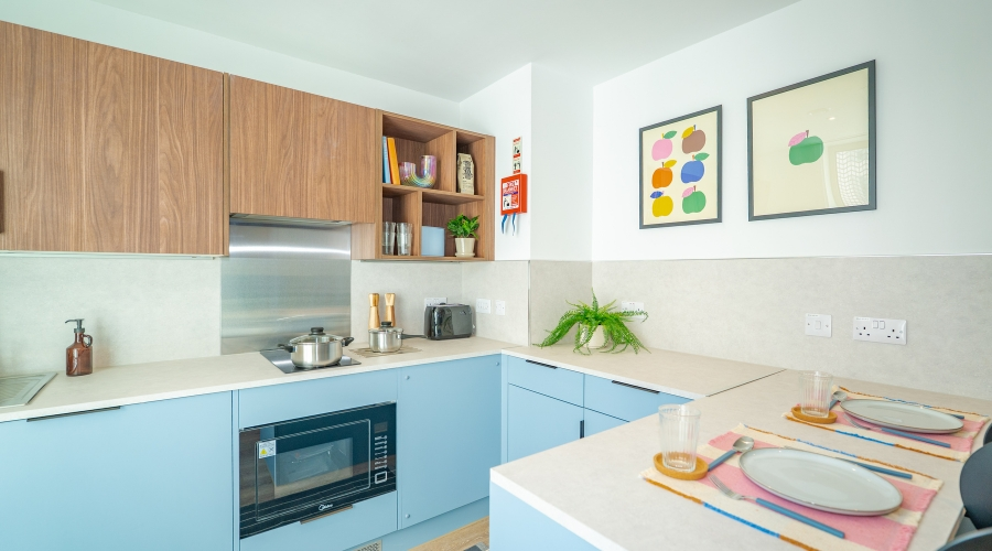 Modern kitchen in The Propeller Quarter student accommodation at Brabazon, featuring integrated appliances, dining space and practical storage