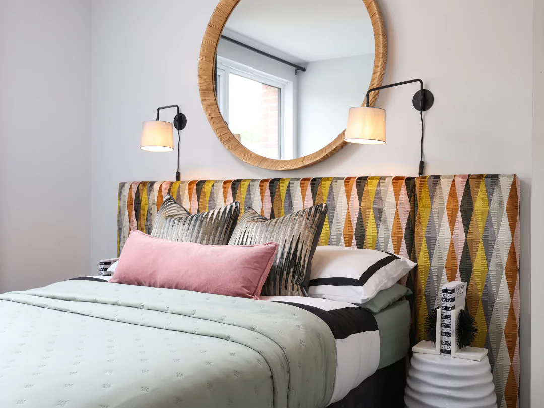 A glimpse into the double guest bedroom featuring a funky headboard and stylish furnishings.